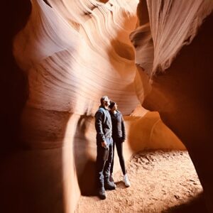 Kylie and Michael standing inside the Upper Antelope Canyon looking out side