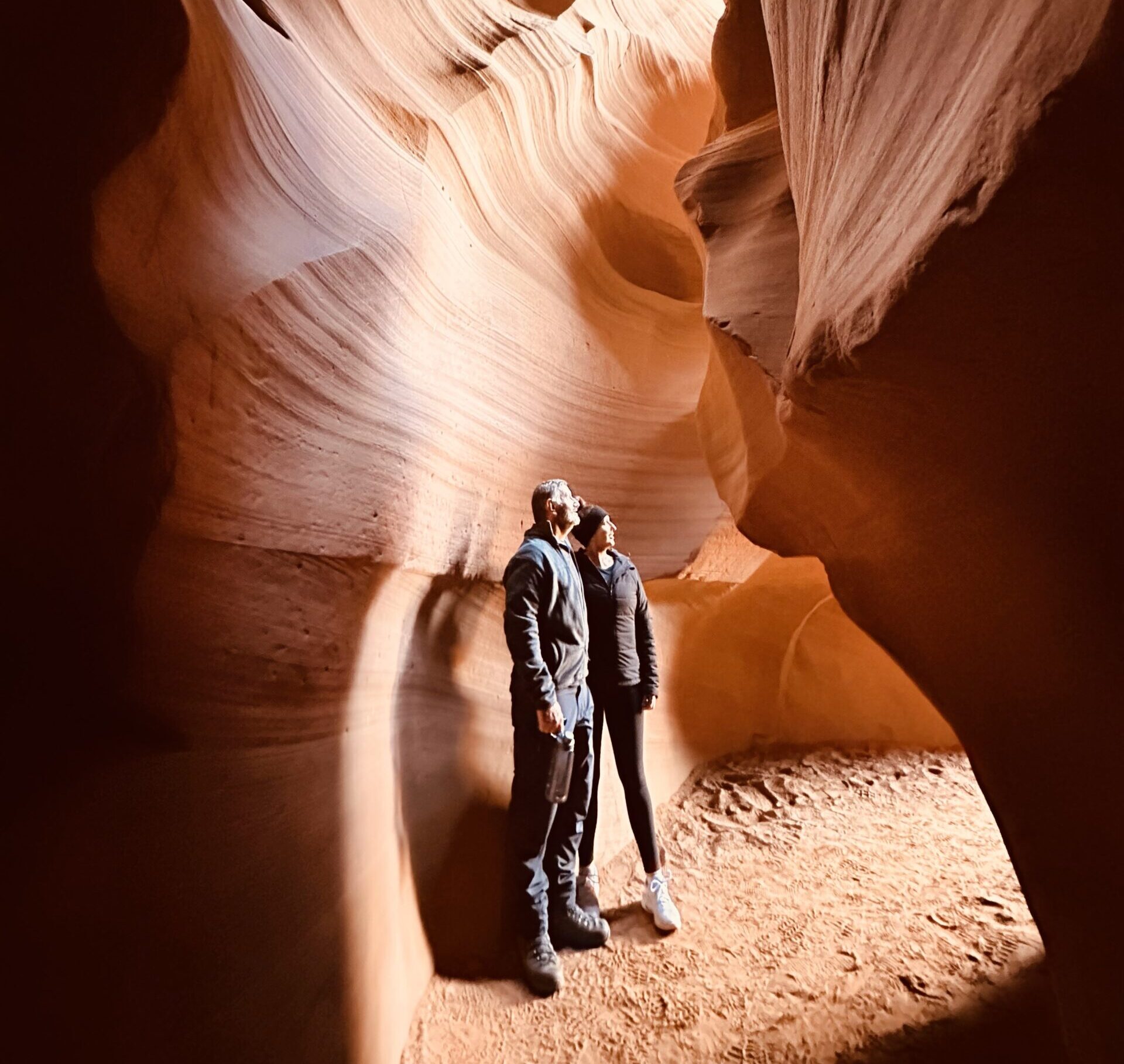 Kylie and Michael standing inside the Upper Antelope Canyon looking out side